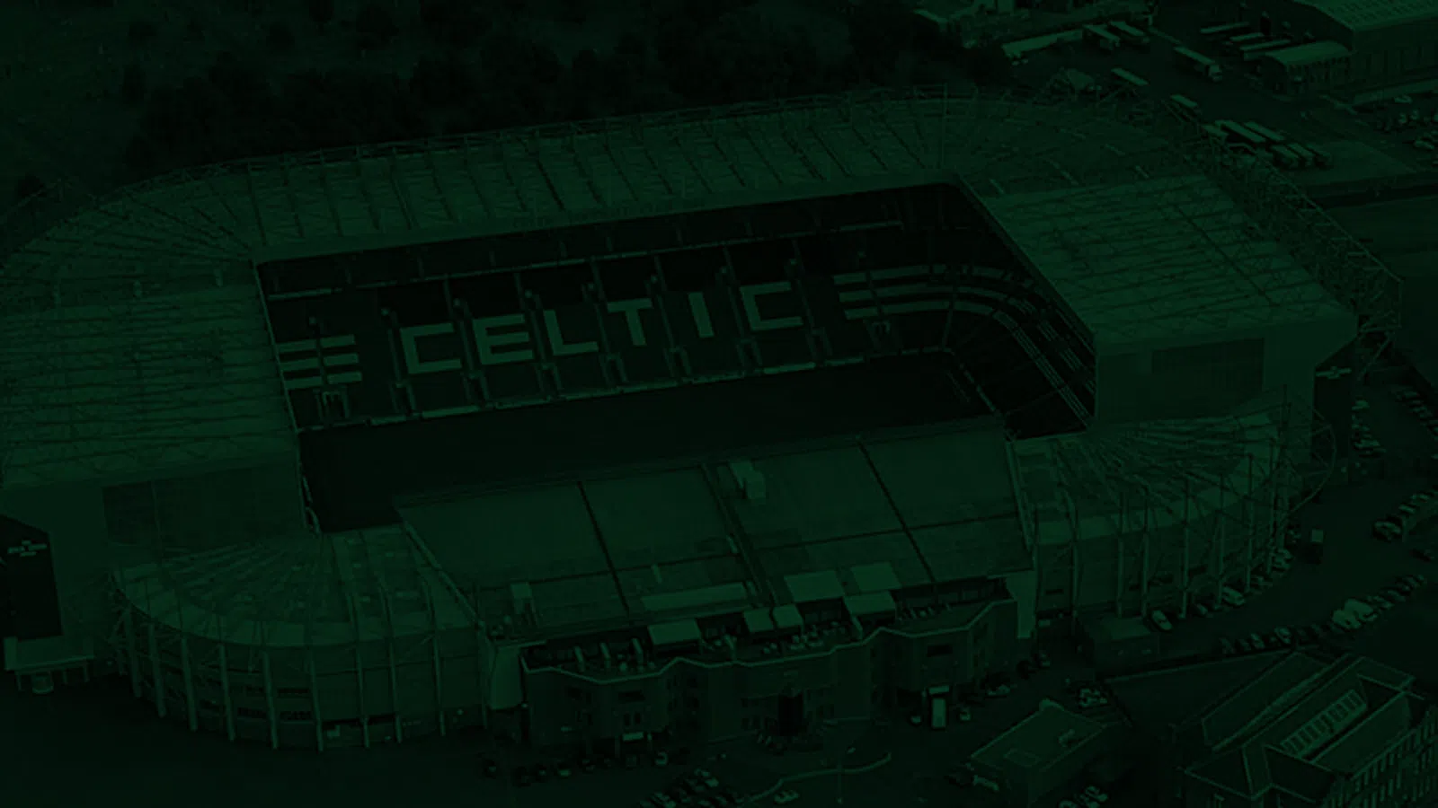Aerial view of an empty Celtic stadium. Surrounding structures and parking spaces are visible in the immediate area.
