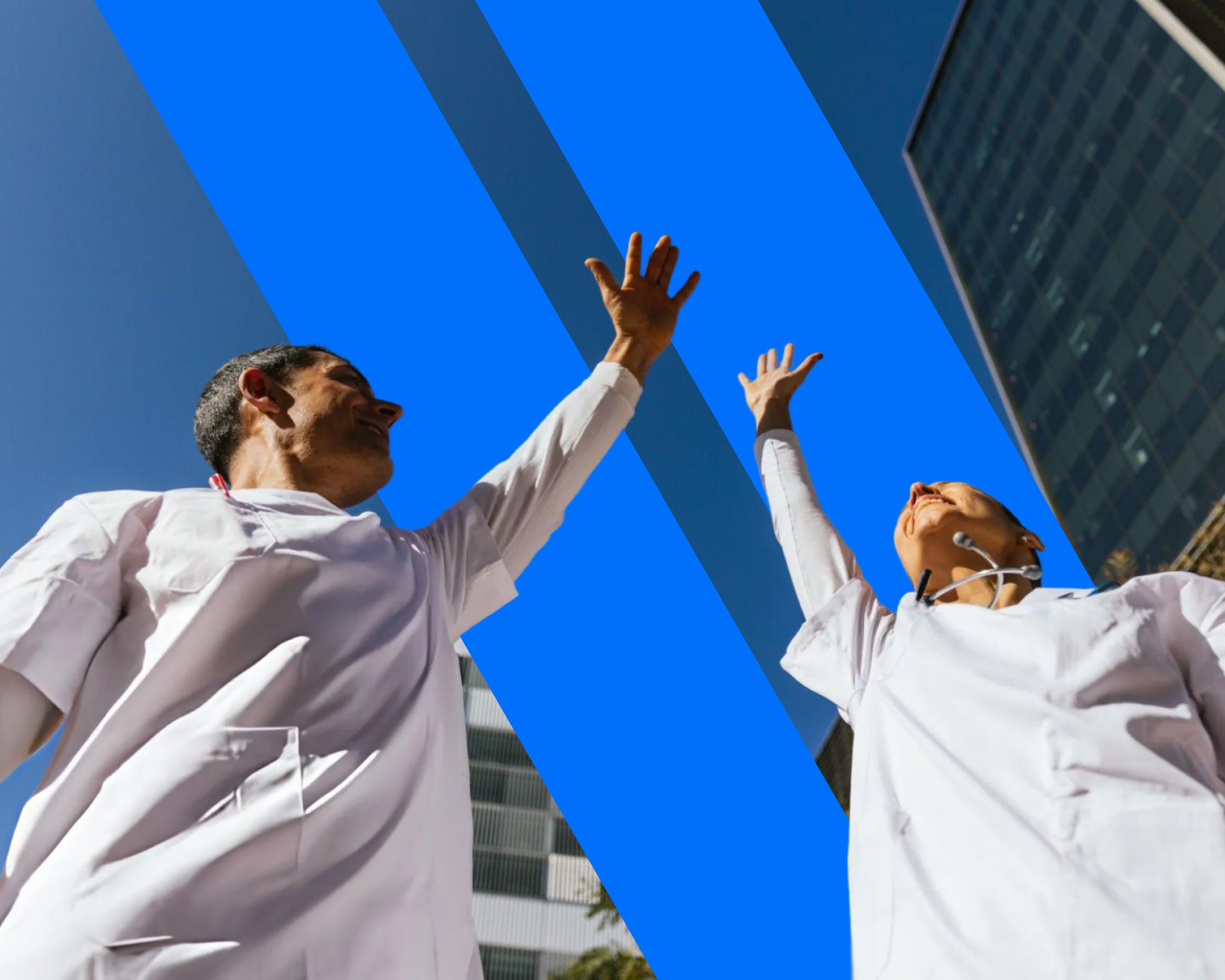 two people in a workspace working on their laptops
