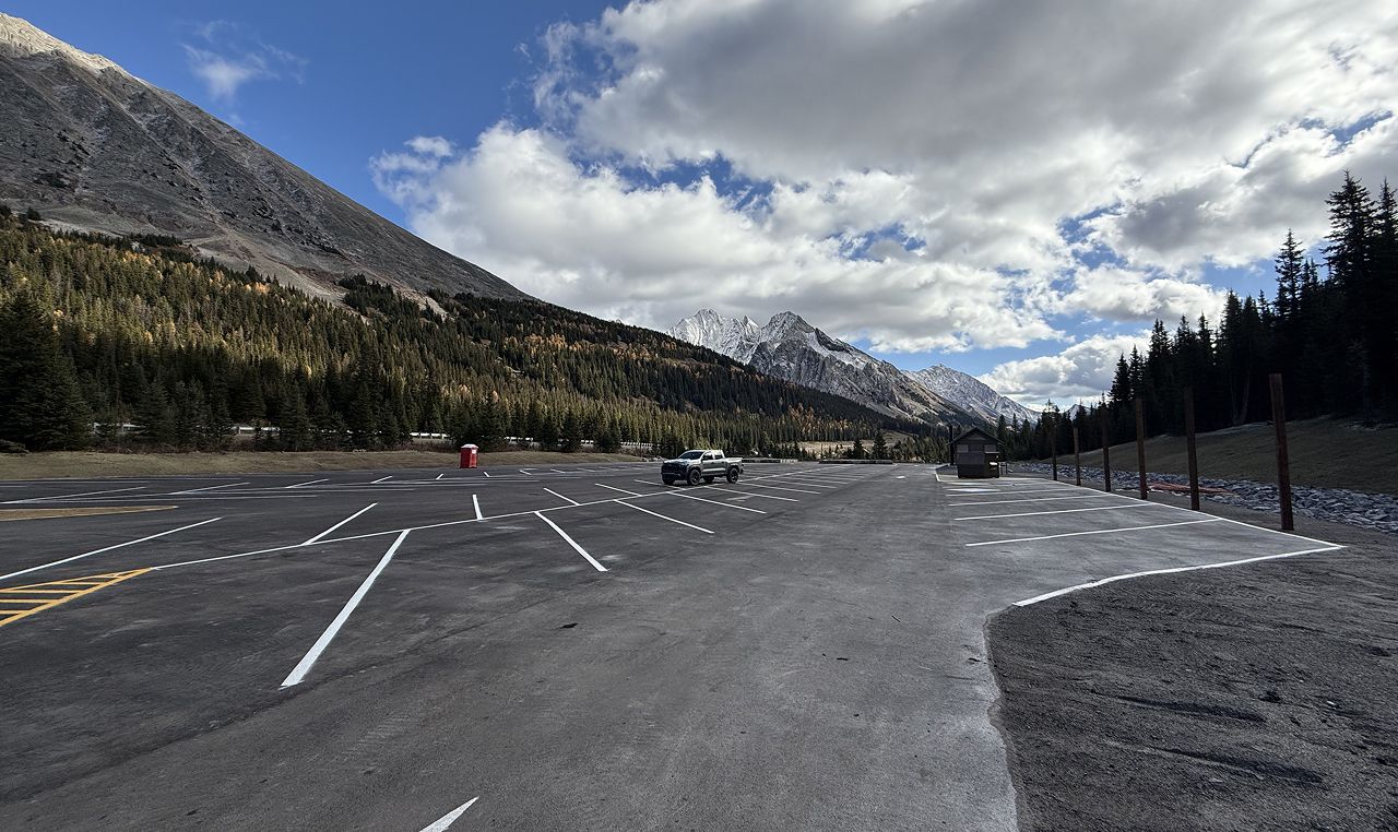 Completed Highwood Meadows parking lot with mountain backdrop in Peter Lougheed Provincial Park