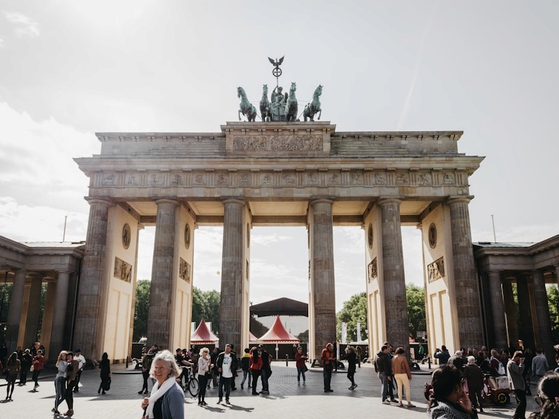 red train travelling near body of water