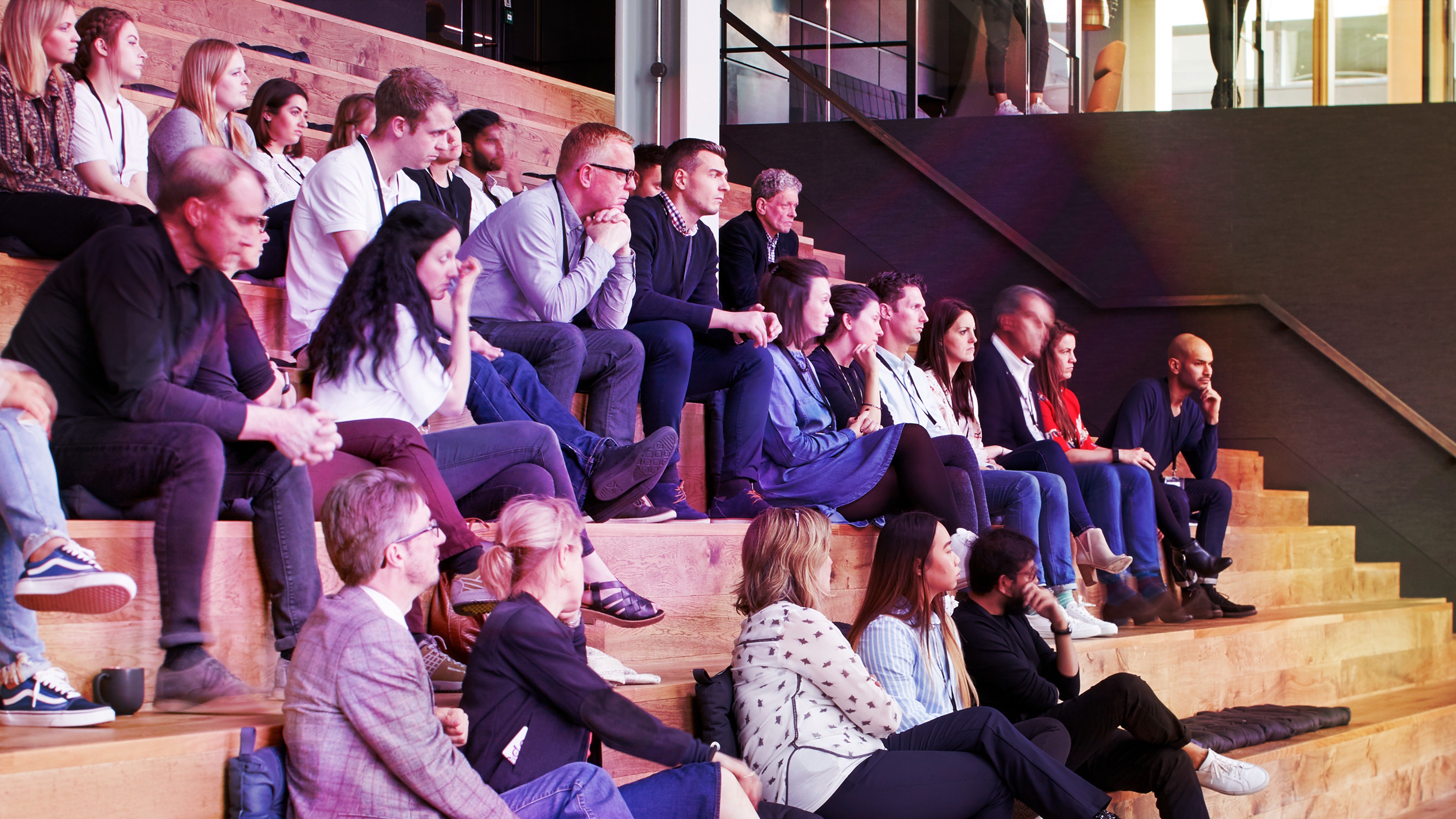 A group of people sit in the forum at Havas London