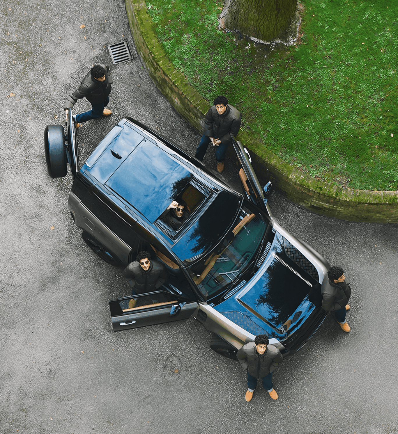 Tree branches against white house and fence