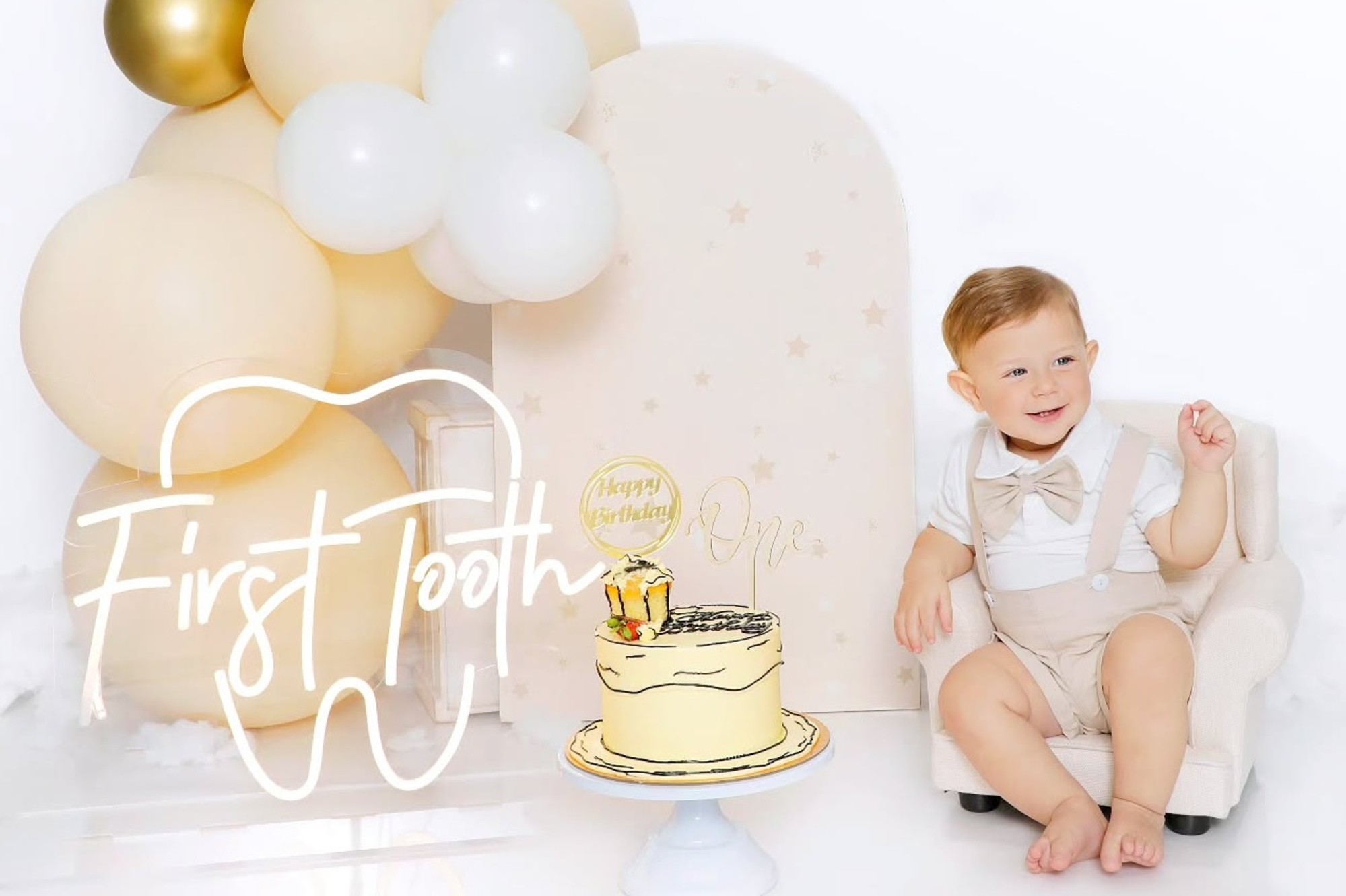 Birthday baby about to do smash cake with pastel yellow cake at Mahvin Photography in Dubai, perfectly captured in joyful moments