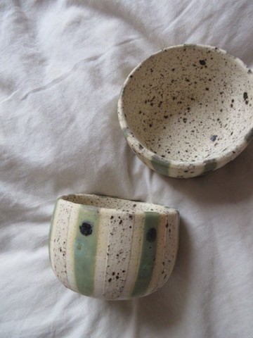 Speckled white ceramic bowl with green stripe detail
