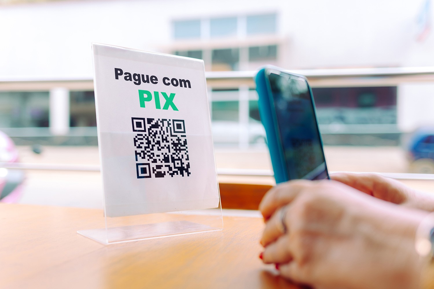 Person paying using Pix, Brazils Instant Payment system
