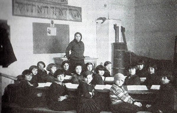 Sara Schenirer posing with young Bais Yaakov students