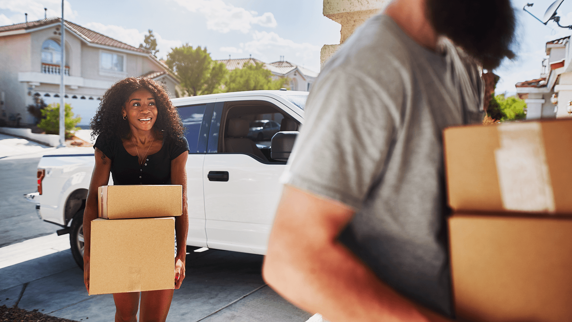 Homeowners moving boxes during a home transition in Las Vegas