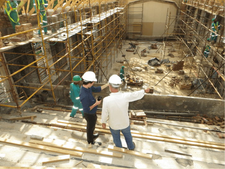 Two project managers working on a busy construction site