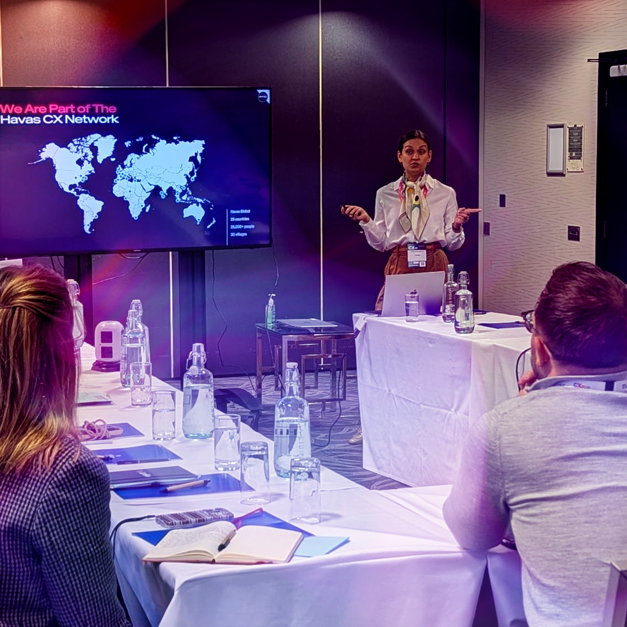 Rachael Brandon-Lai speaks to a room full of attentive people about turning insight into action