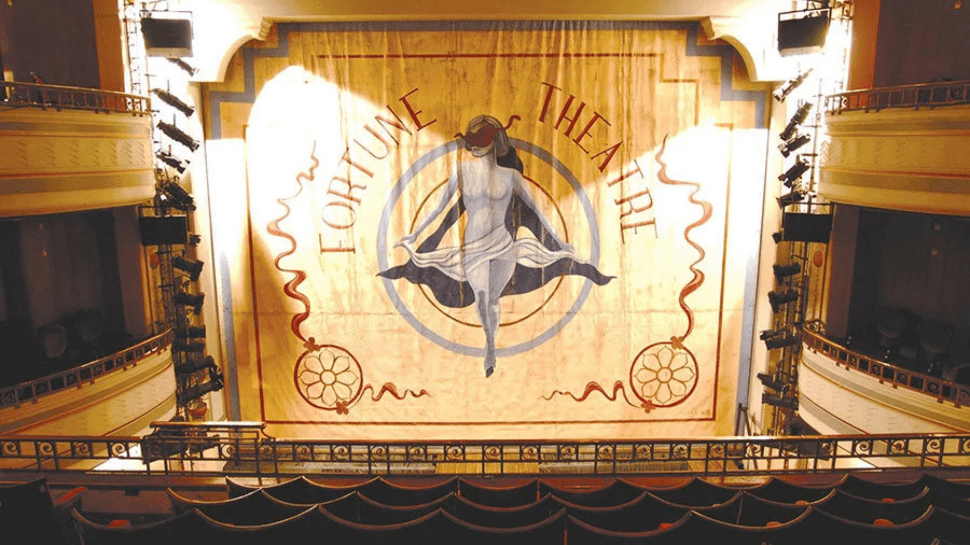 a view of the stage curtain of London's Fortune Theatre