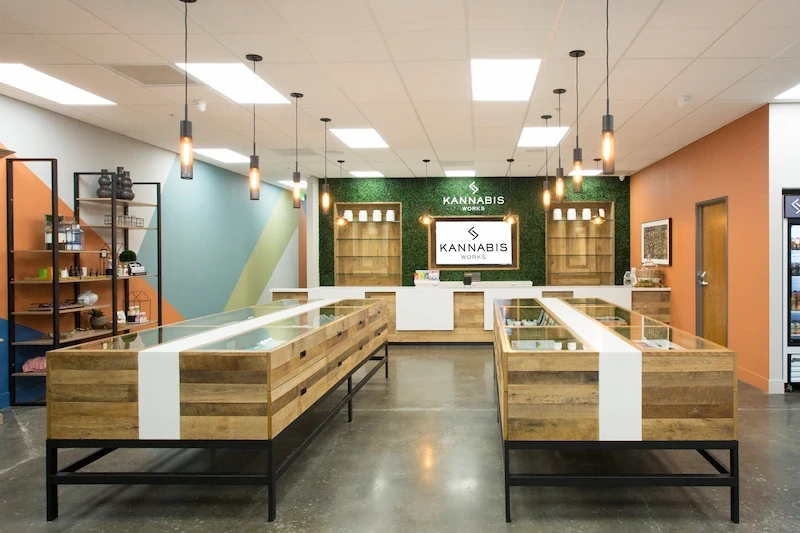Spacious Kannabis Works interior featuring wood display islands and industrial-style lighting.