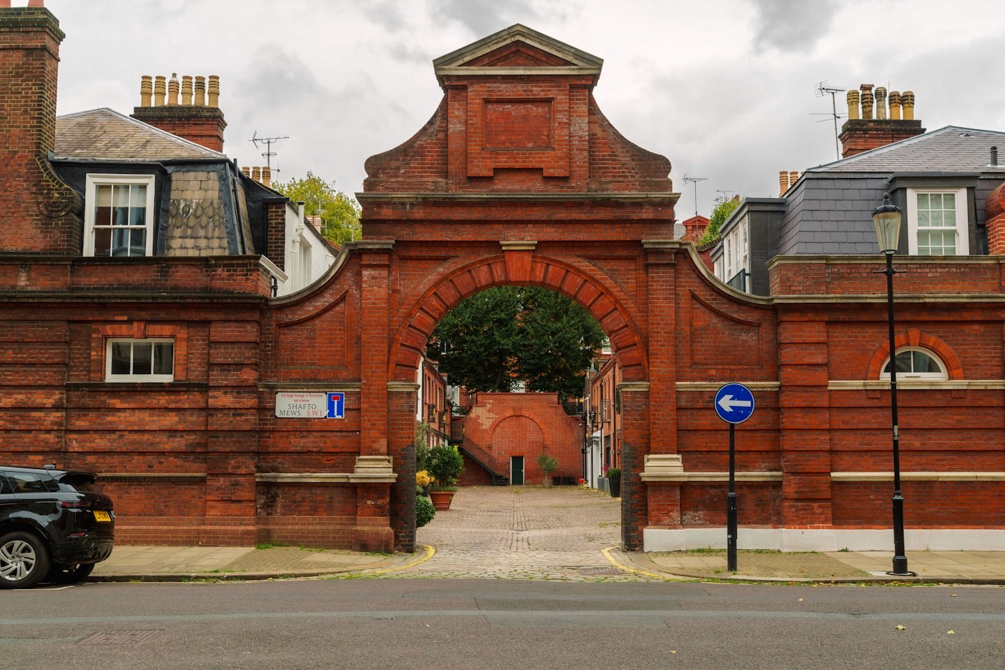 Brick archway opening onto a quiet London courtyard