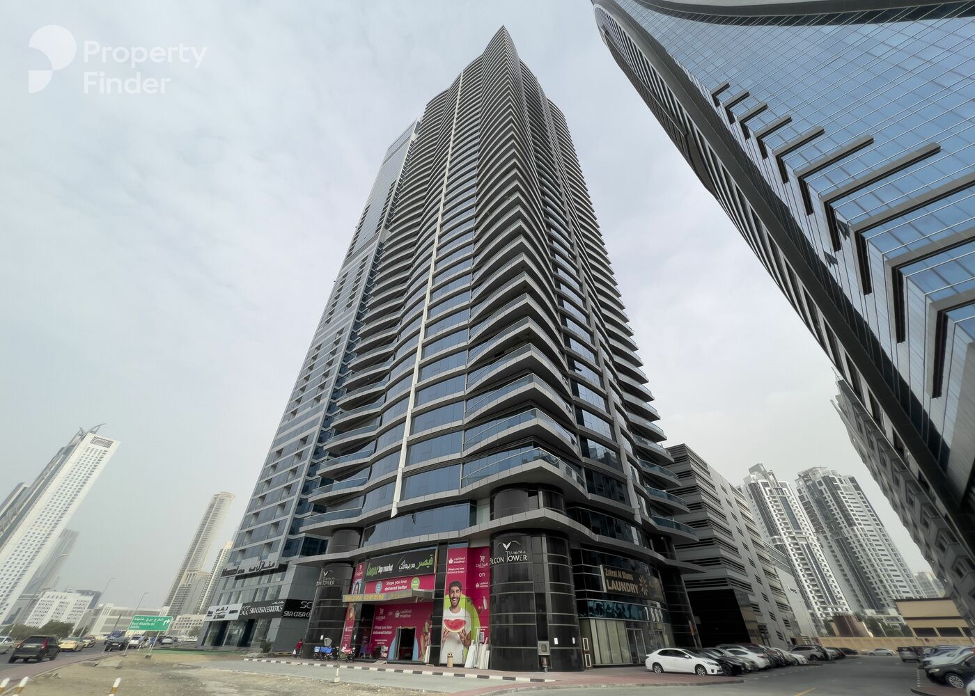 Ground view of Falcon Tower entrance. Professional real estate agent guidance for commercial and residential spaces.