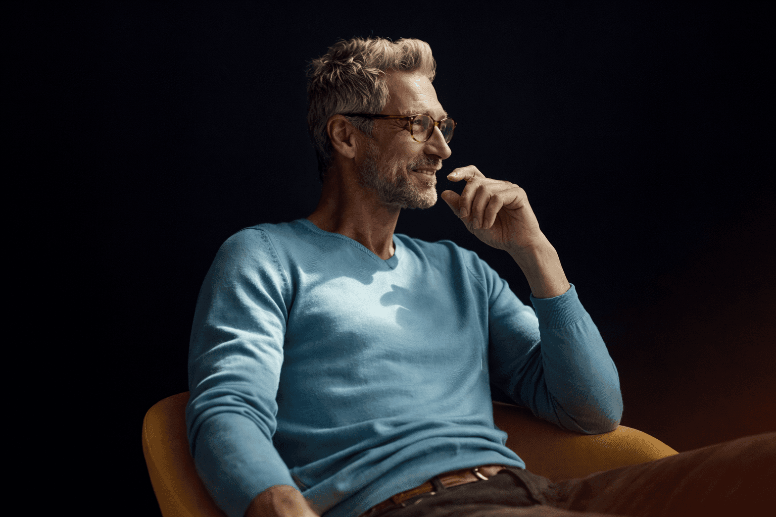 Sunlight highlights a woman with short hair holding coffee.