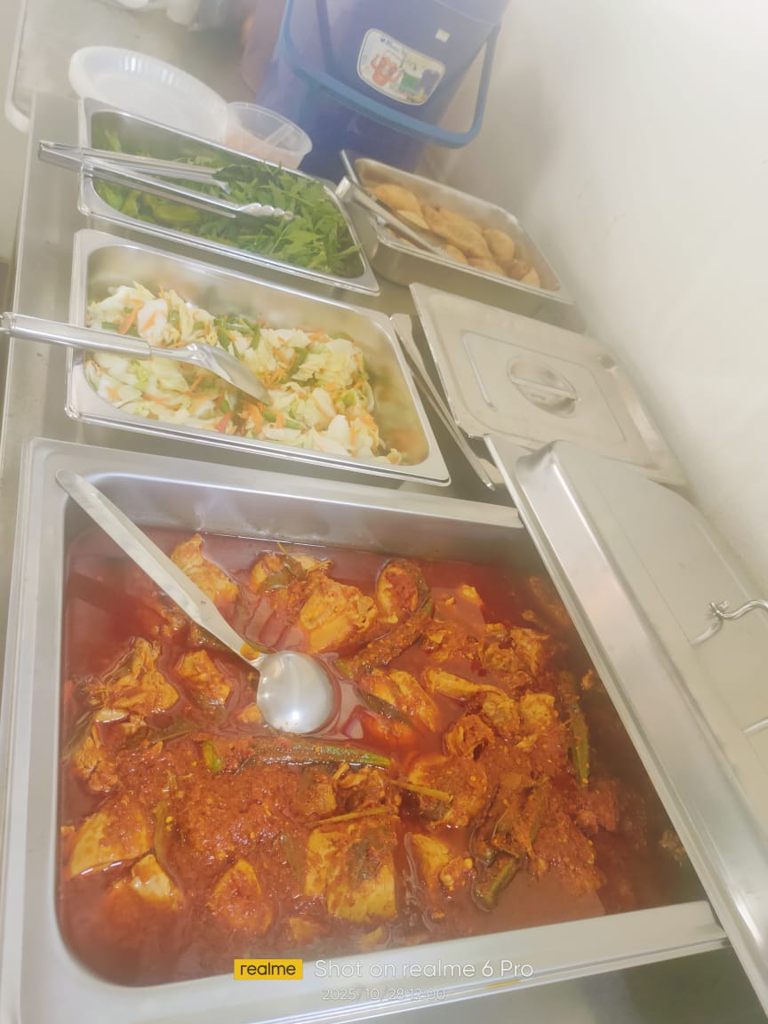 A selection of delicious Malaysian food served at the lunch treatment organized by Mr. Bijay, featuring a rich chicken dish.
