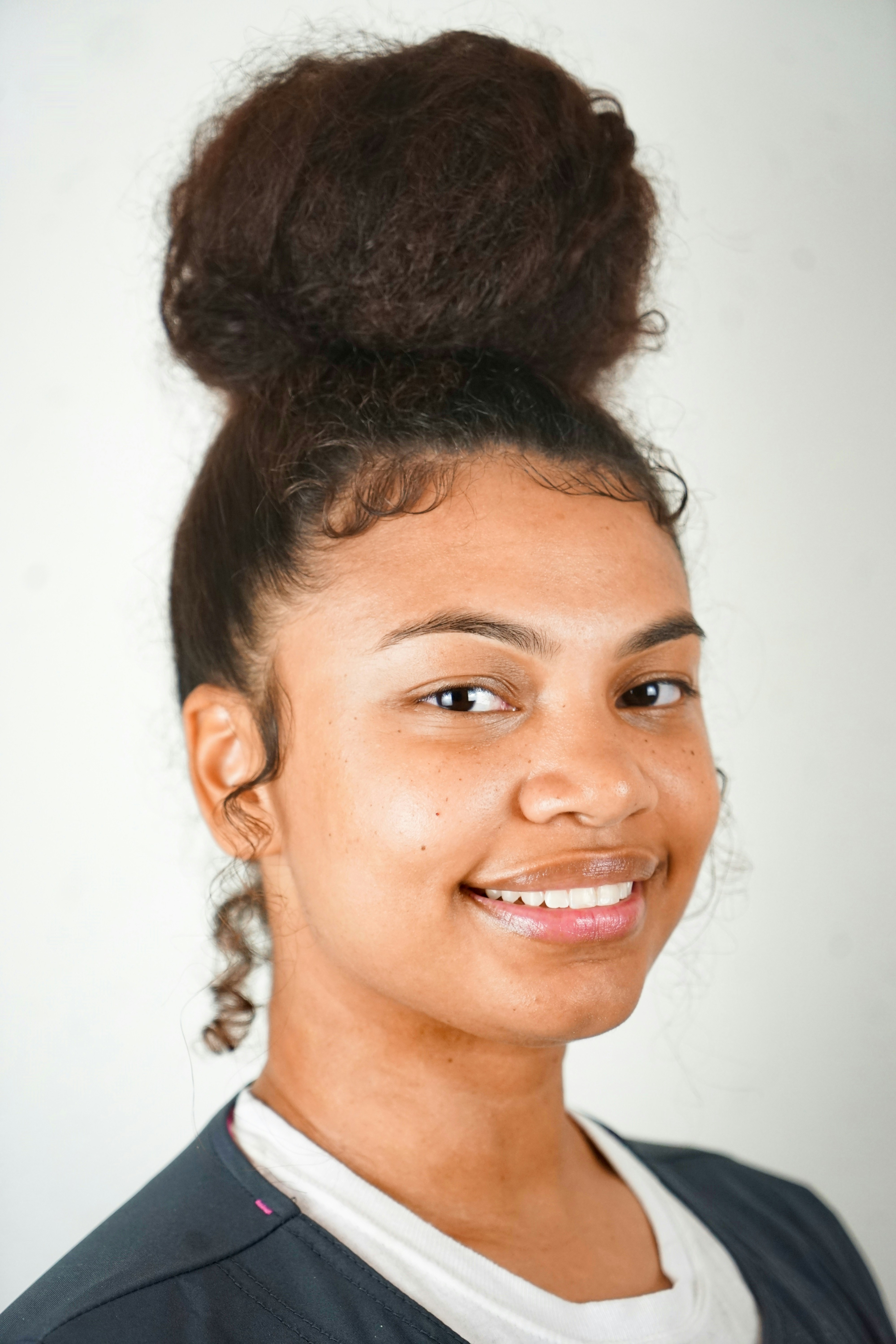 man in black collared shirt smiling