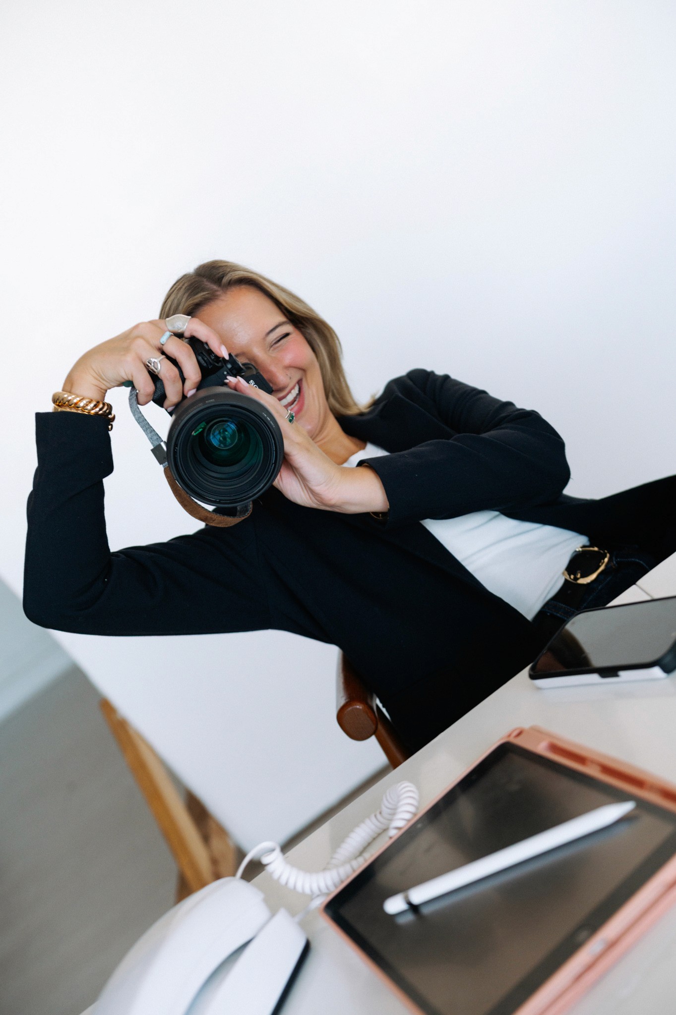 A thoughtful young person with dark hair gazes to the side, captured in soft black and white lighting.