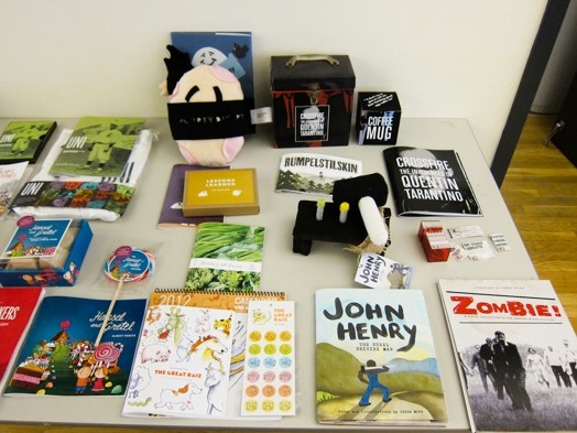 a table full of booklets and flyers and miscellaneous merchandise