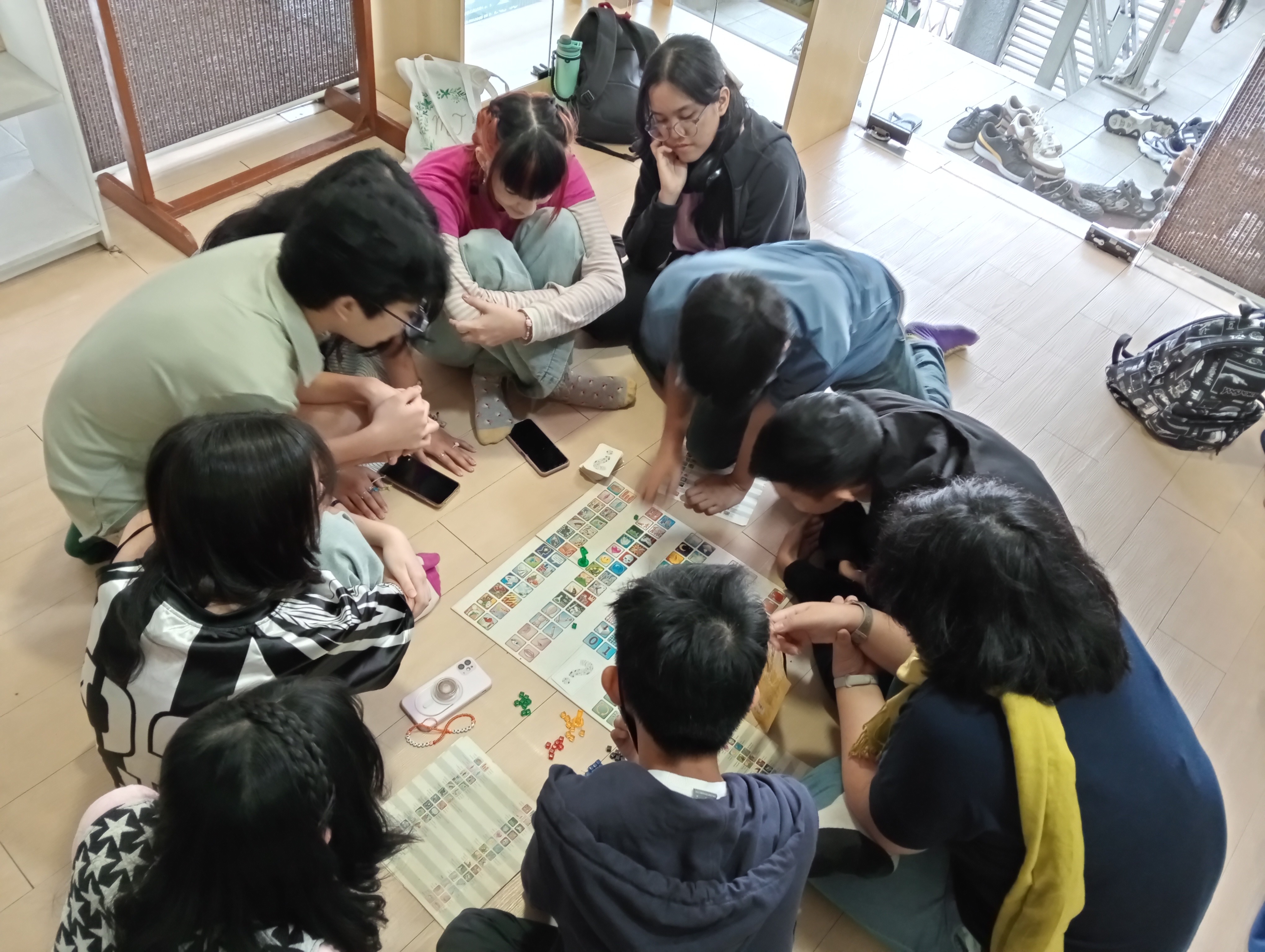 A group of young people playing a board game together.