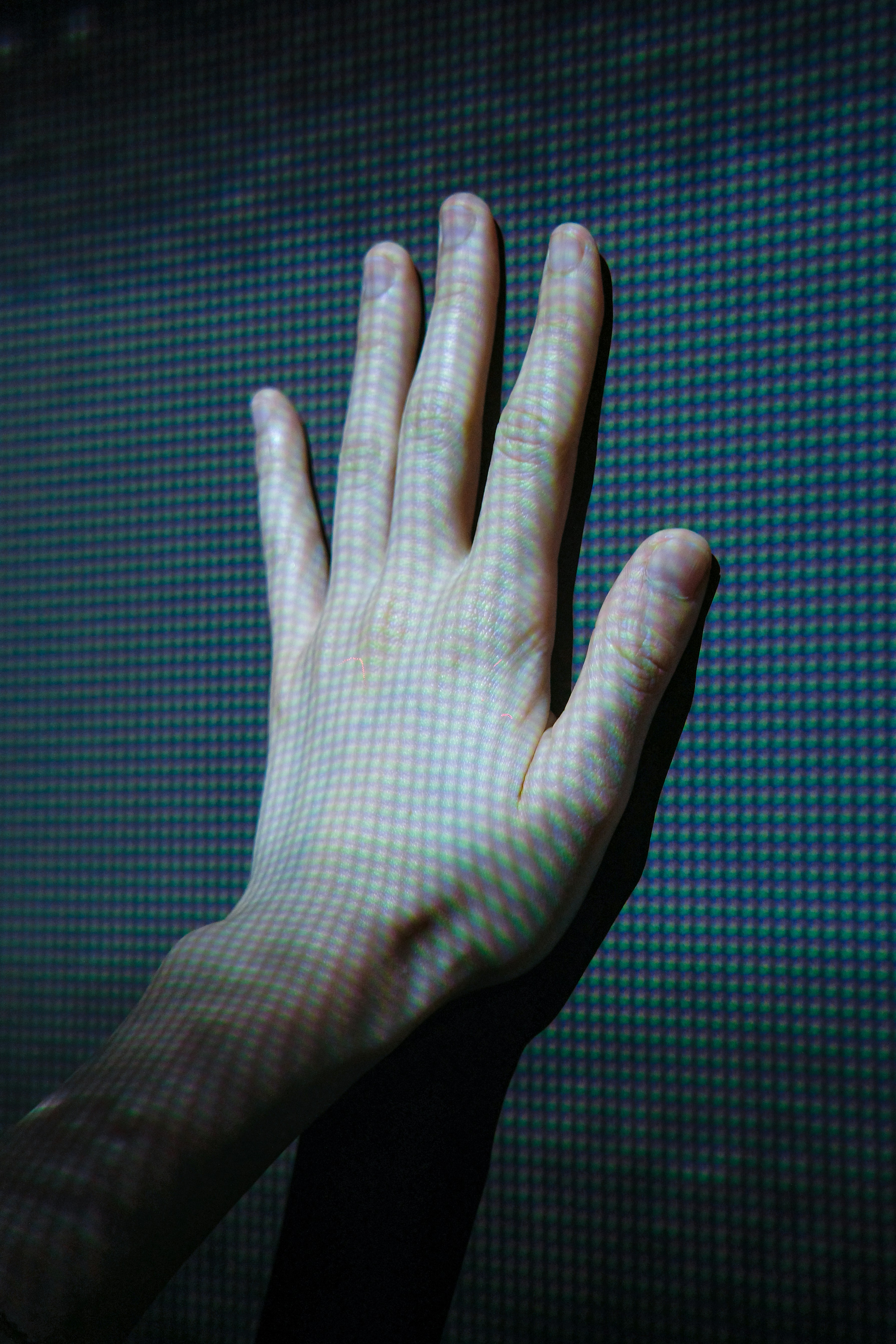 Hand touching a digital screen