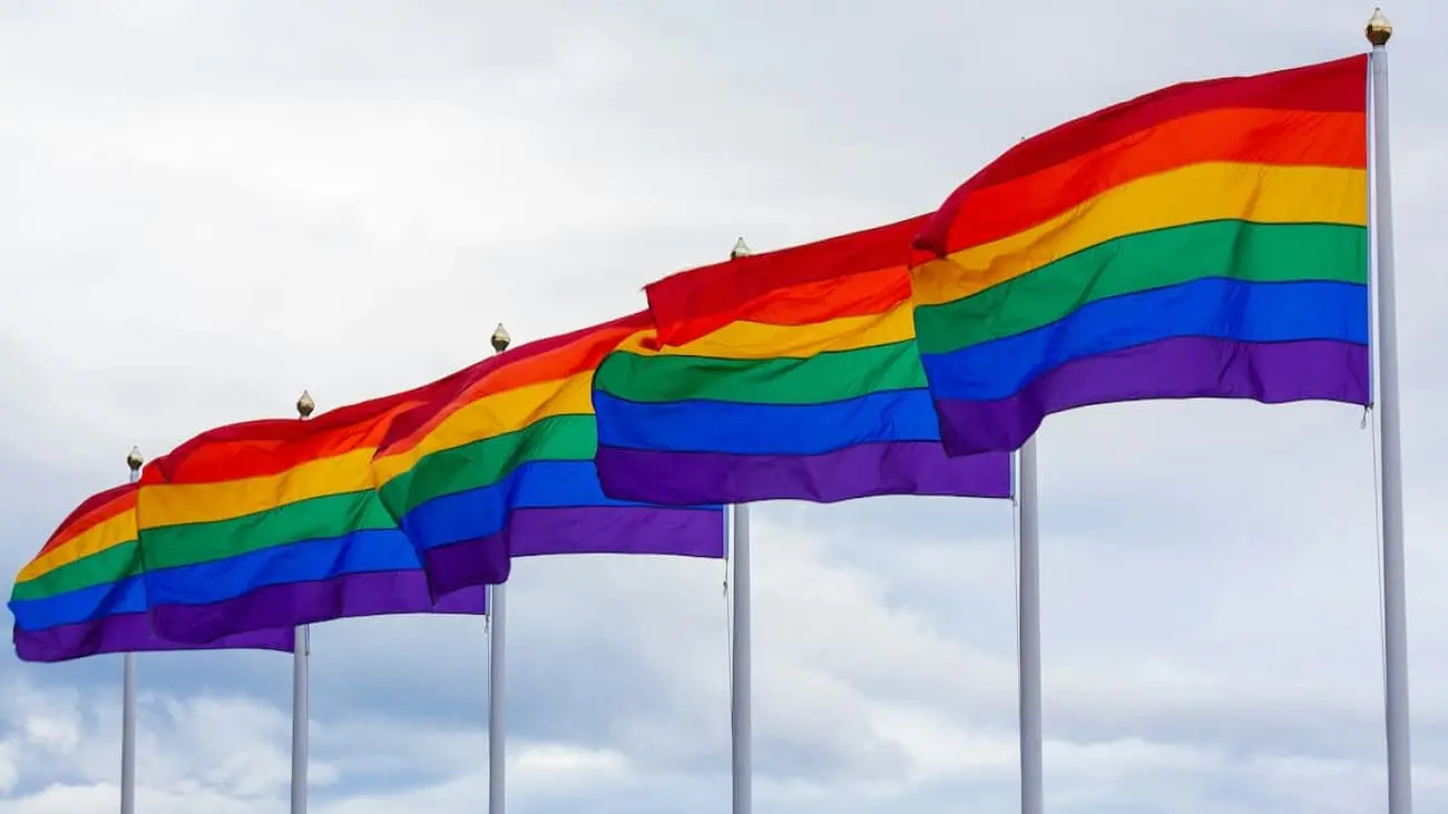 Rainbow flags waving in the wind, a symbol of acceptance and diversity in football.