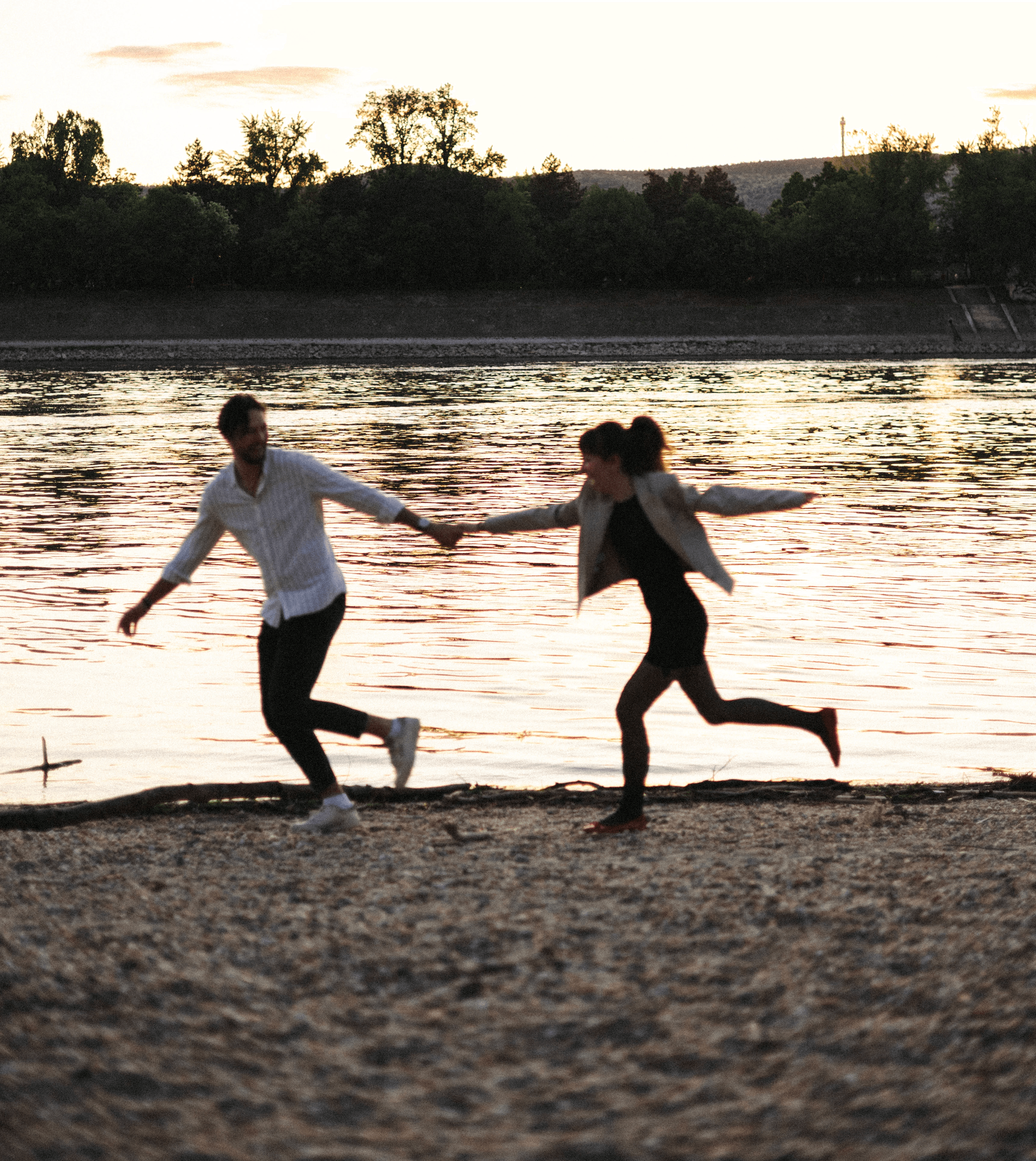Woman siting in lotus pose meditating over a brightly lit green hill