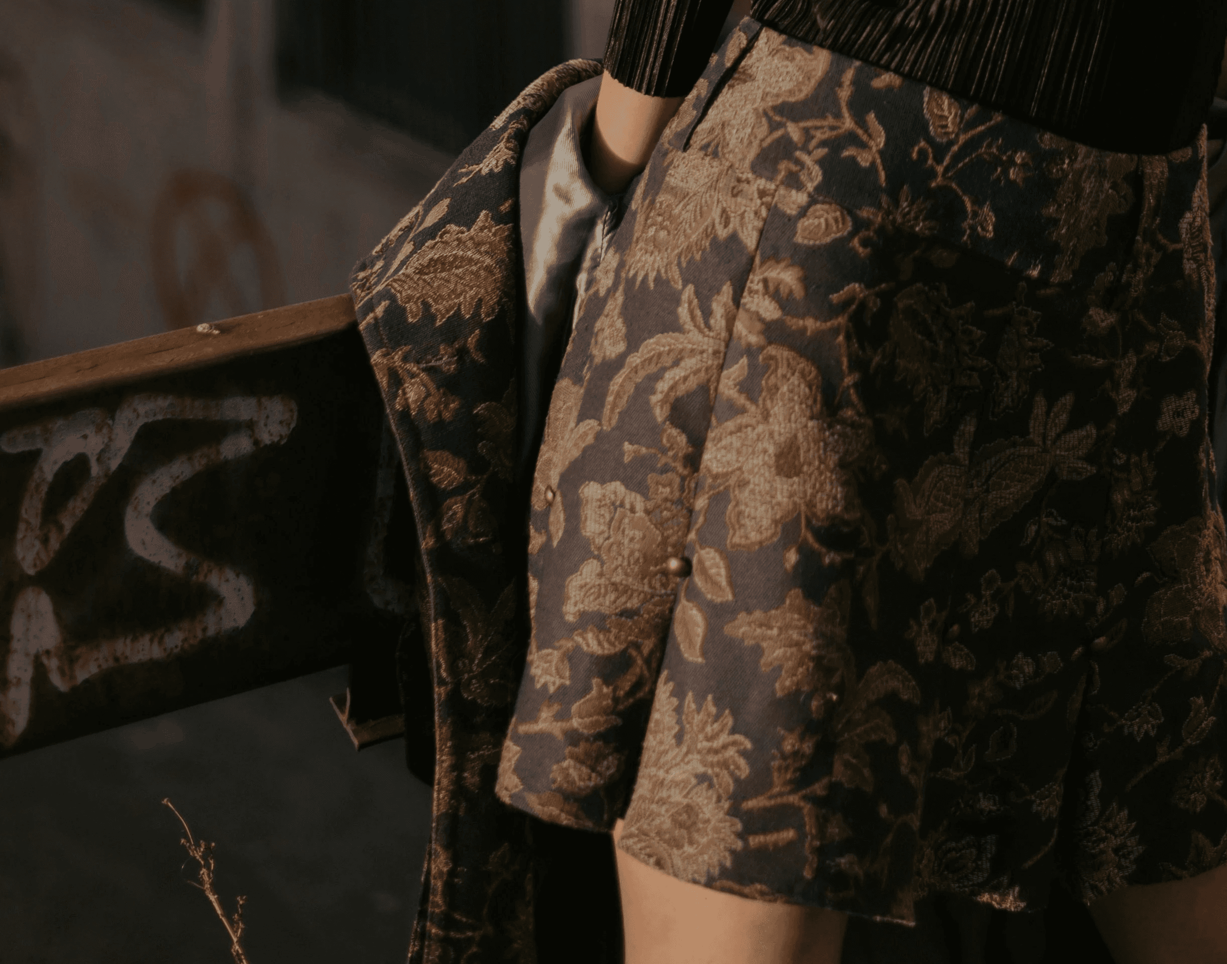 woman wearing black long-sleeved shirt and gray floral flare skirt