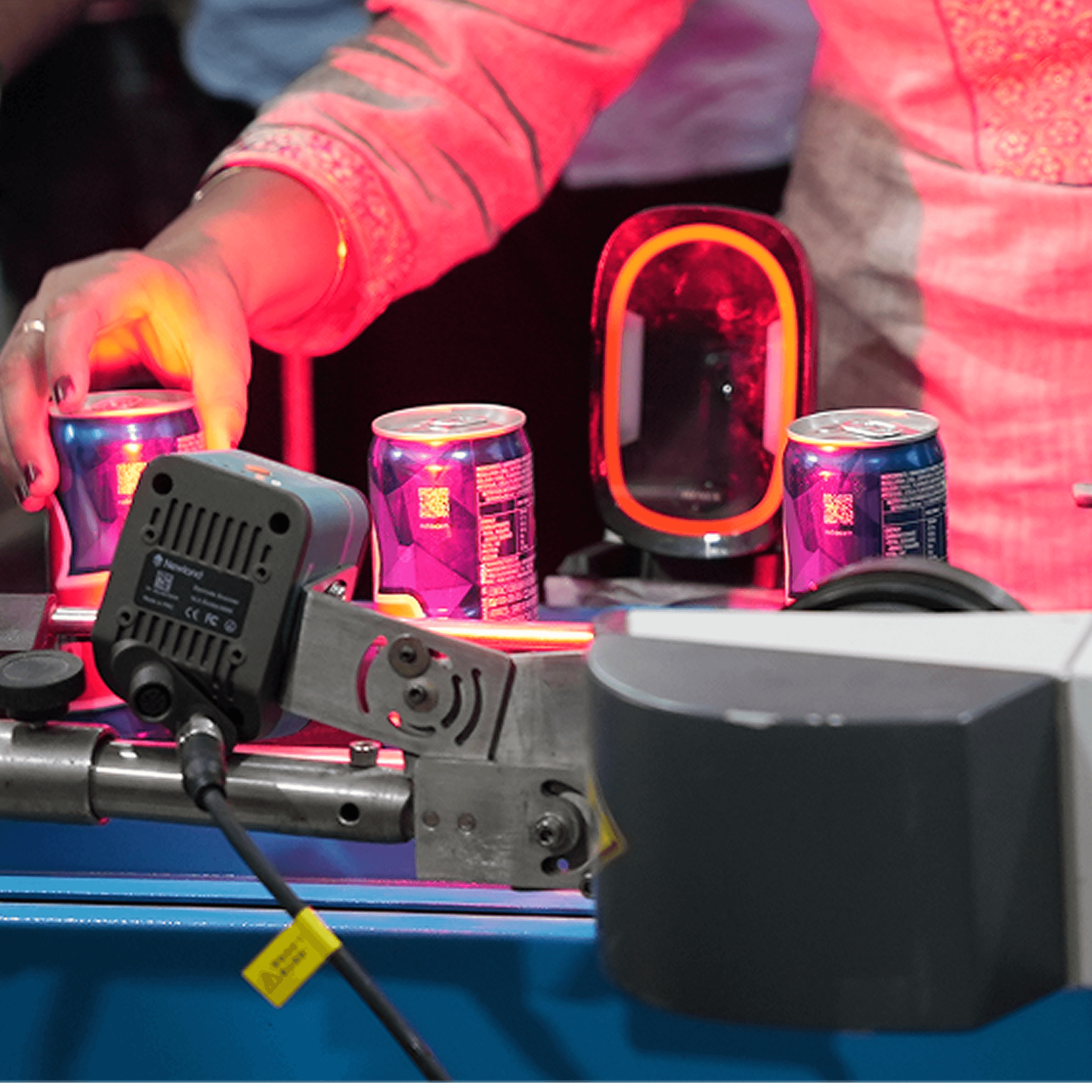 Woman in red outfit poses by a red telephone booth.