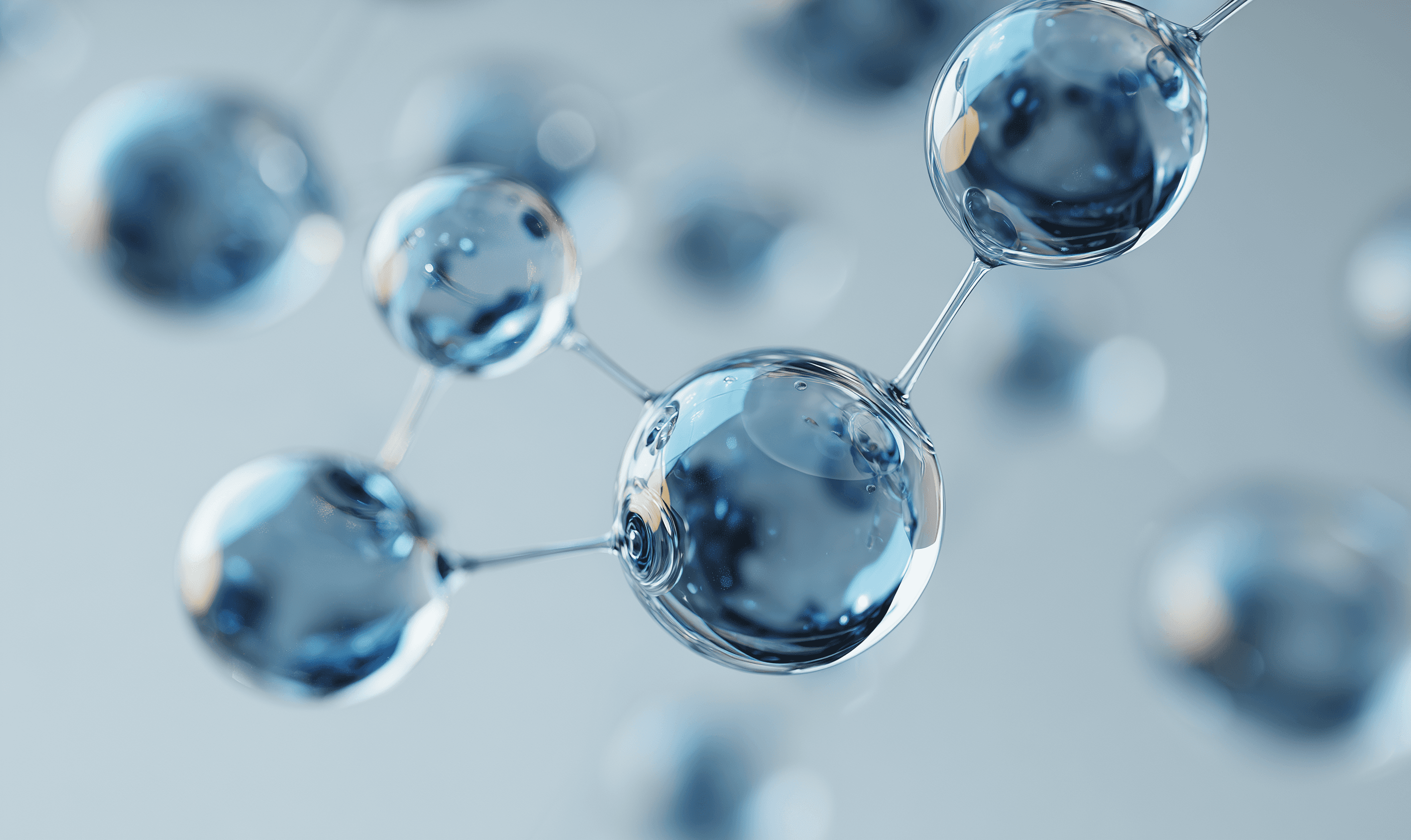 Abstract 3D spheres connected like a molecule on a soft blue background.