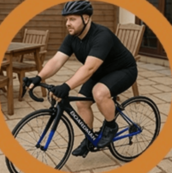 a man in a blue shirt smiling at the camera