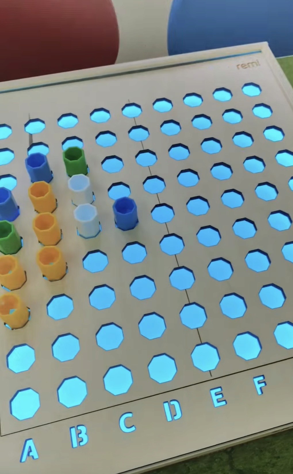 A woman with auburn hair and a gray coat over a white sweater, set against a neutral background, exuding a minimalist aesthetic.