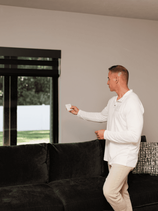 A woman looking at a wall with a clock on it