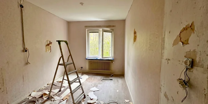 a man in a yellow shirt is working on a roof