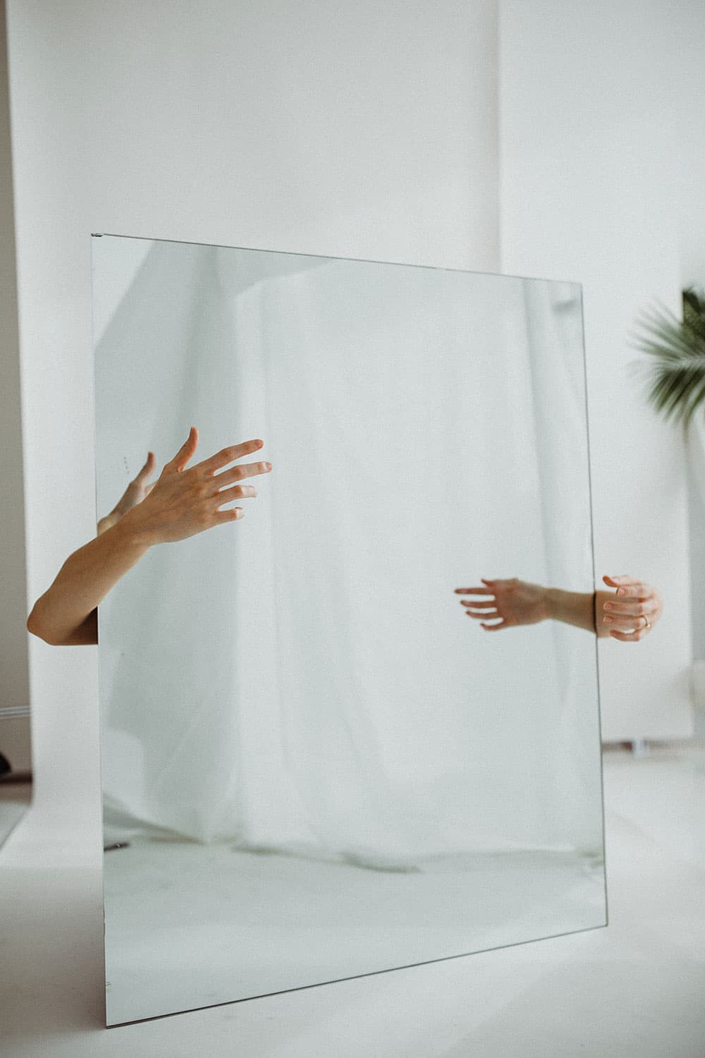 Mirror with some hands coming from behind it