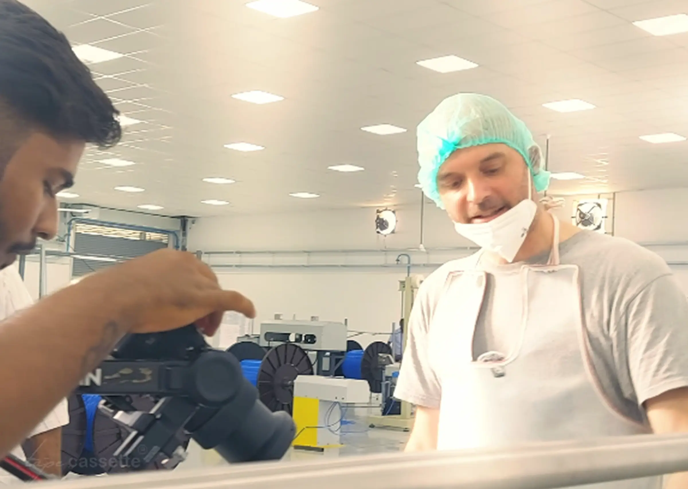 Man holding camera with tripod for Janatics industrial videography setup