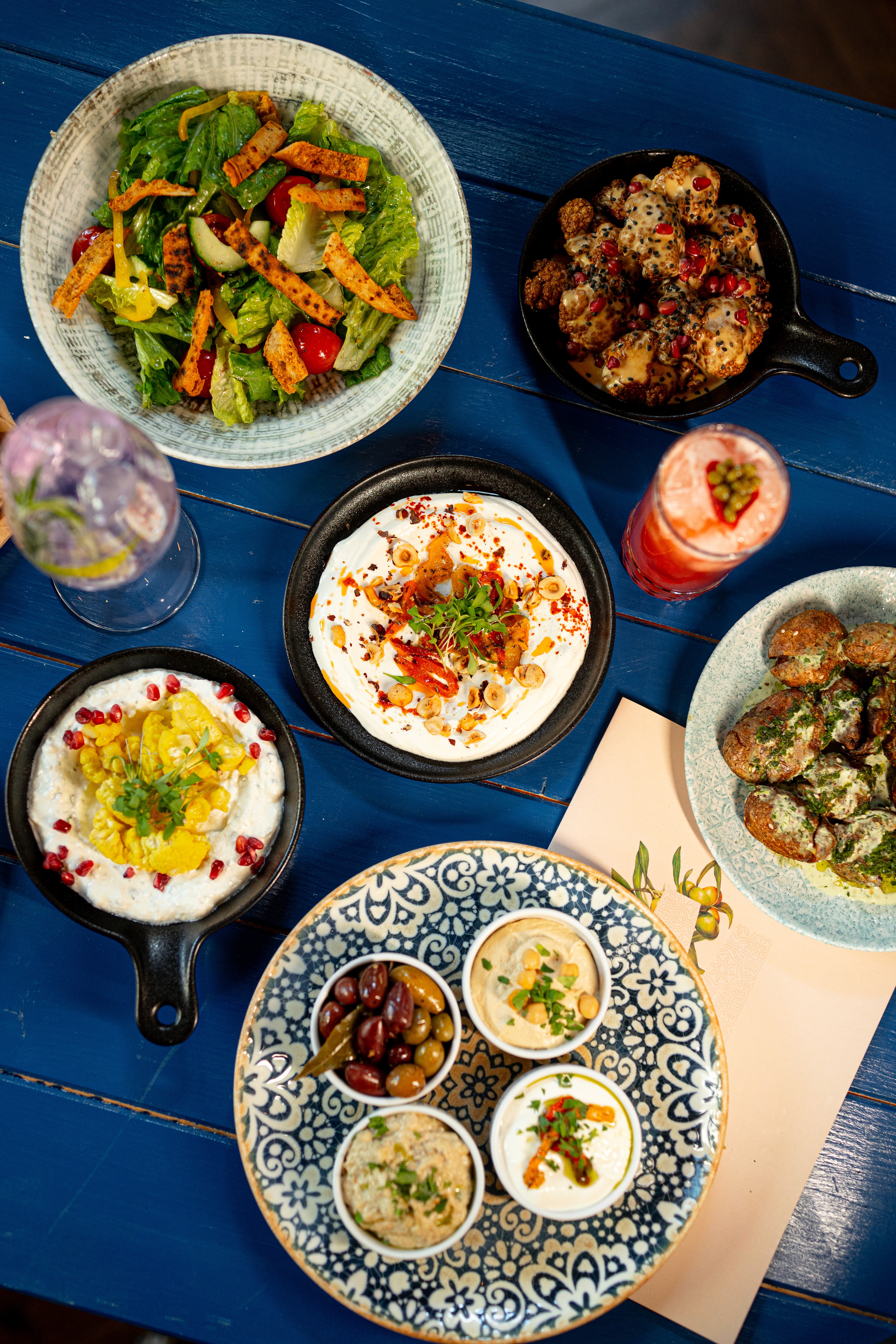People sharing food at Mazeltov restaurant