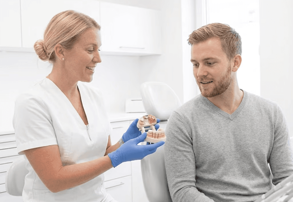 Dentist explaining dental crowns as a treatment option for gap teeth.&nbsp;
