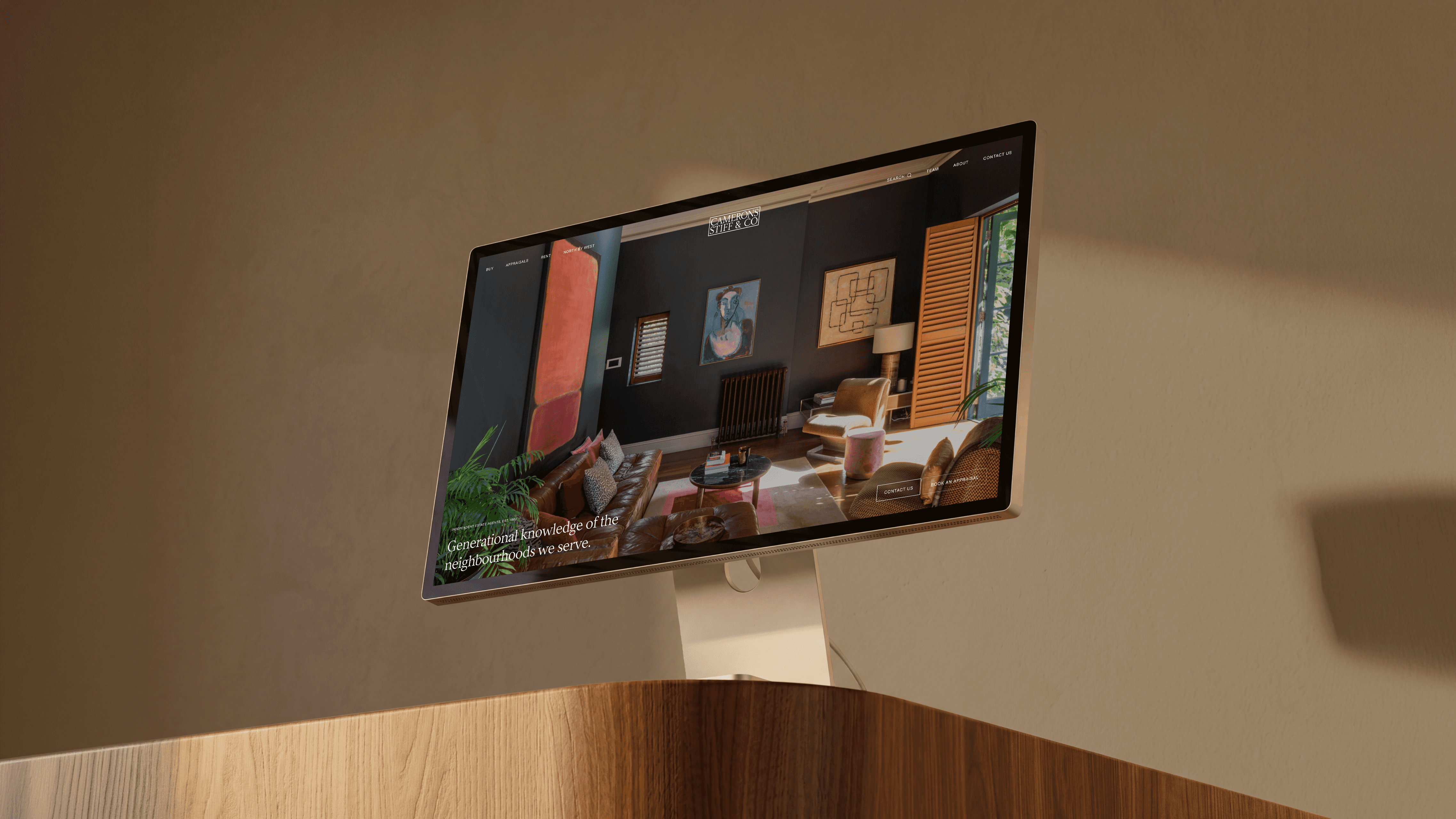 Camerons Stiff & Co website showing a styled living room on a desktop monitor