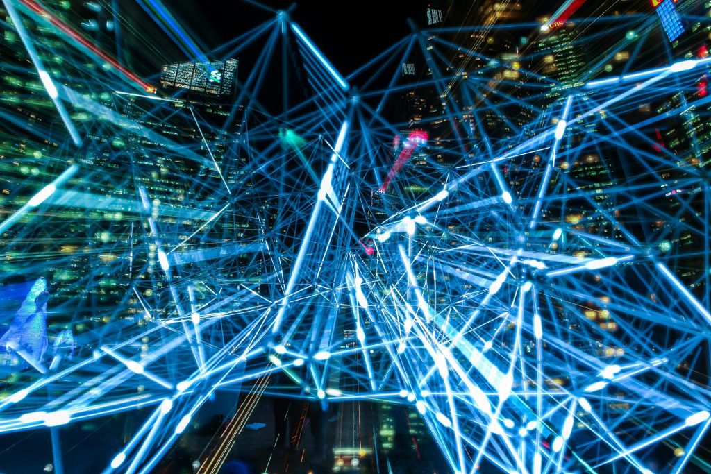 Glowing blue network lines over a city at night, symbolising open APIs and innovation in Shopify Plus