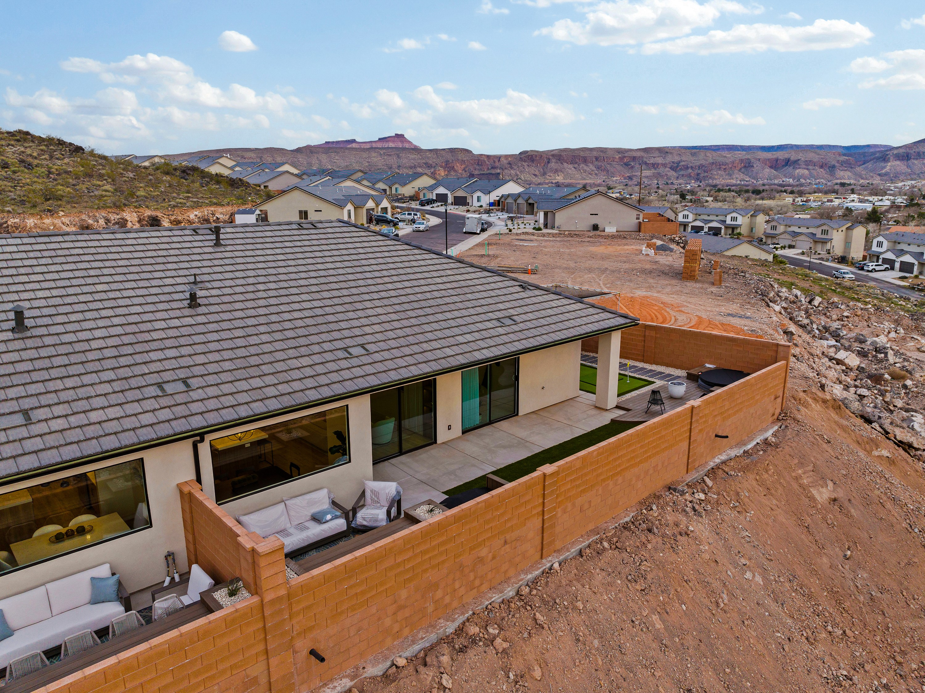 Aerial view of the backyard of The Painted Horizon in Hurricane, Utah highlighting the outdoor barbecue patio area designed for entertaining.