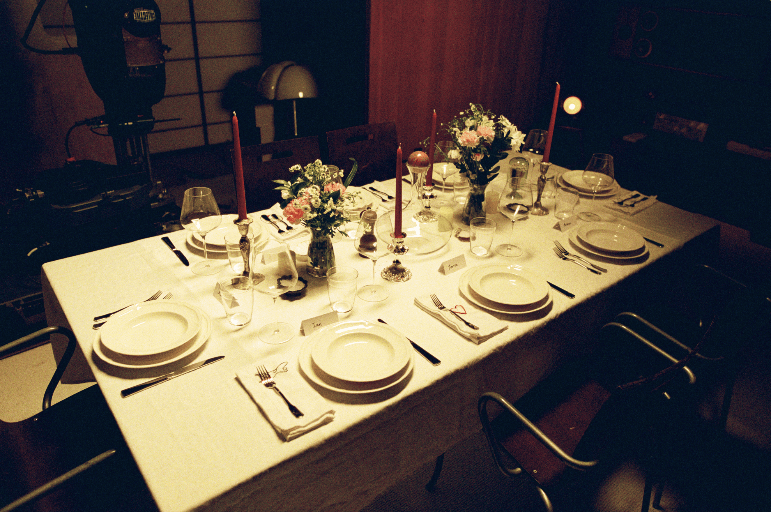 A decorative floral arrangement spills over a table draped in red fabric, creating an elegant atmosphere.