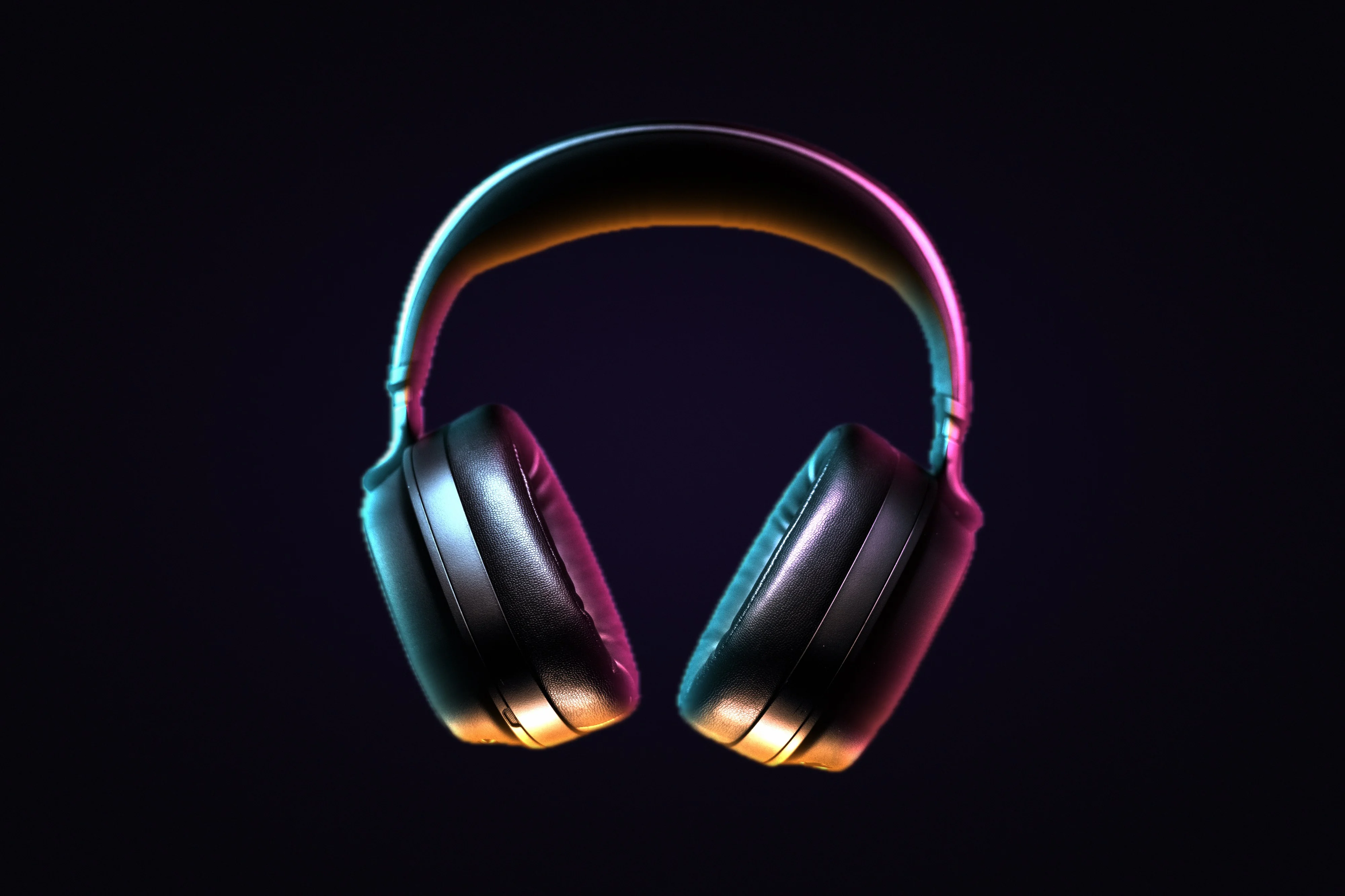 SODIUM ONE headphones lit in cyan and magenta on black