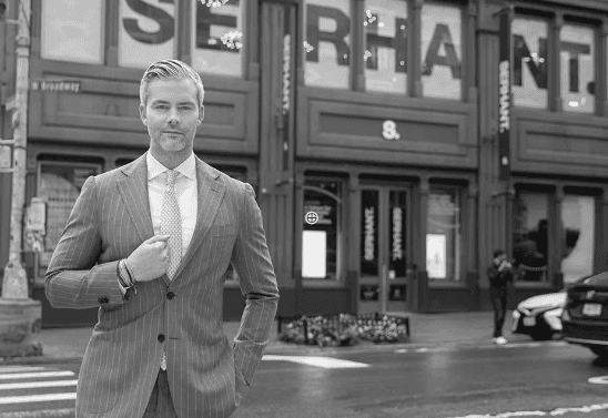 A glowing, floating cube illuminated in blue and orange hues at night, surrounded by blurred figures in a surreal outdoor setting.