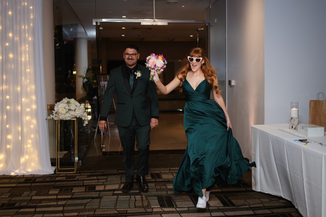 Bridesmaid and groom entering reception