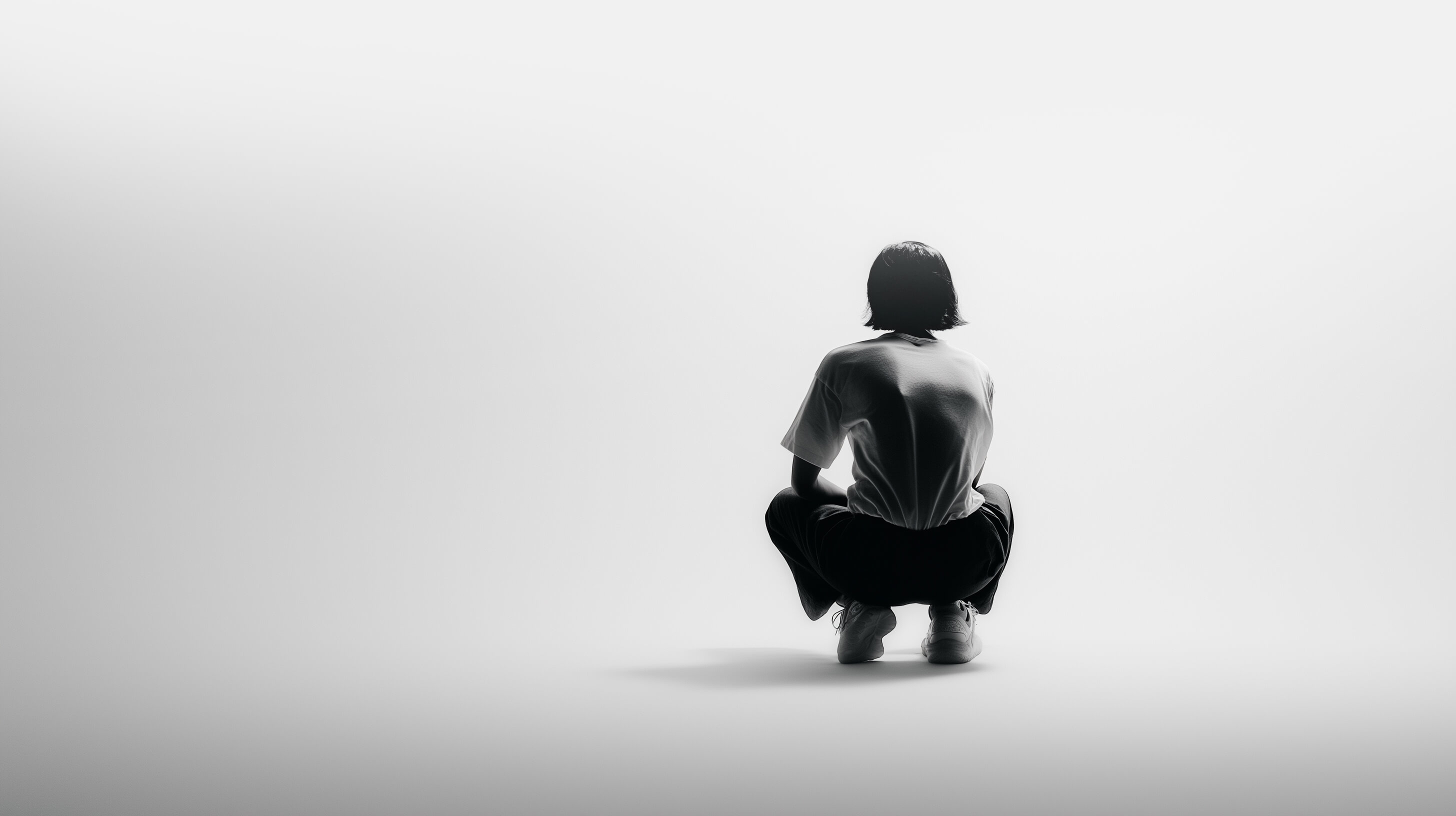 Person crouching in a calm, reflective pose representing taking control of your health with Eternal