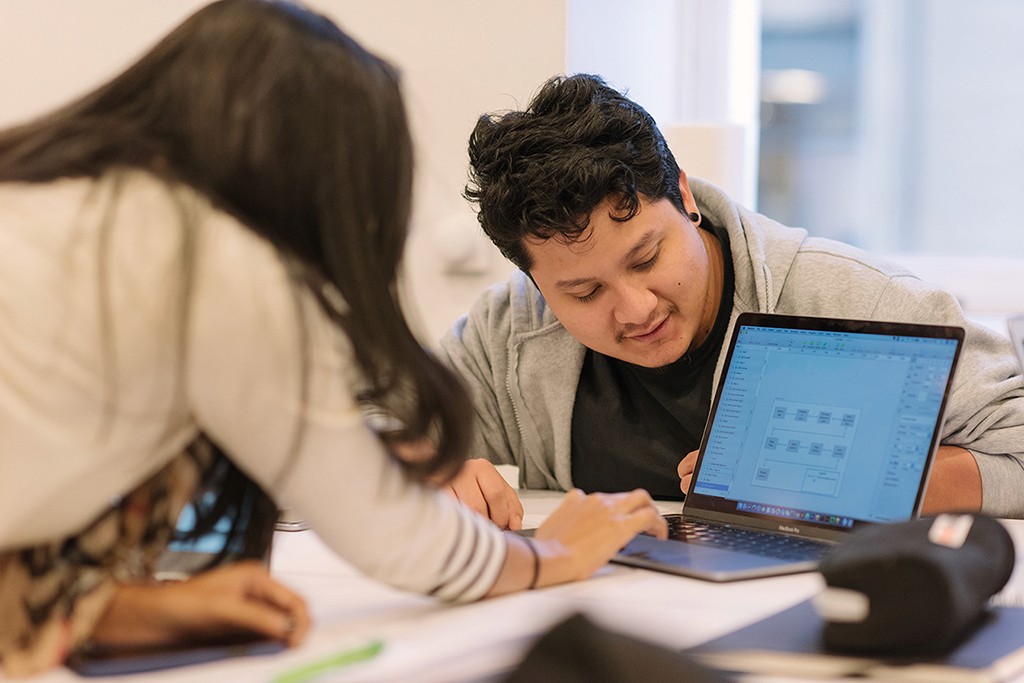 Learners gathered around a systems flow diagram, decoding how the pieces connect.
