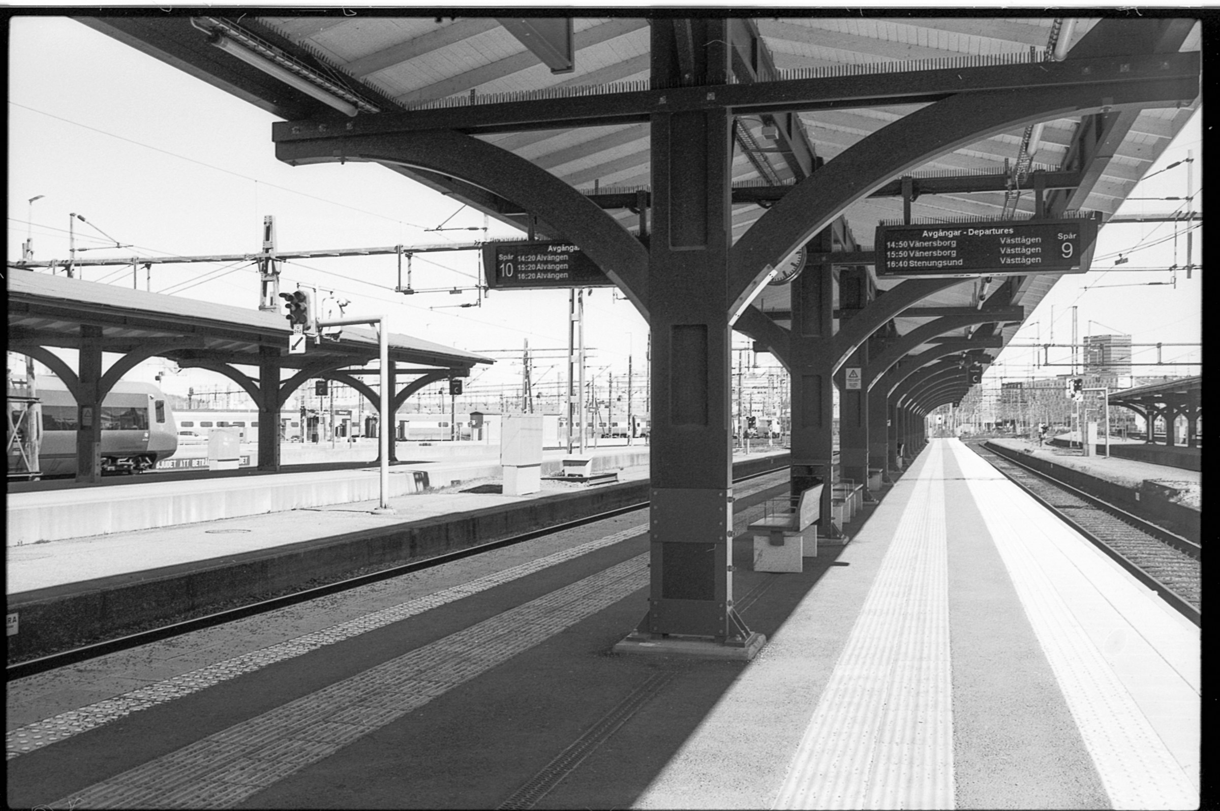 Empty train station platform with arched roof structure