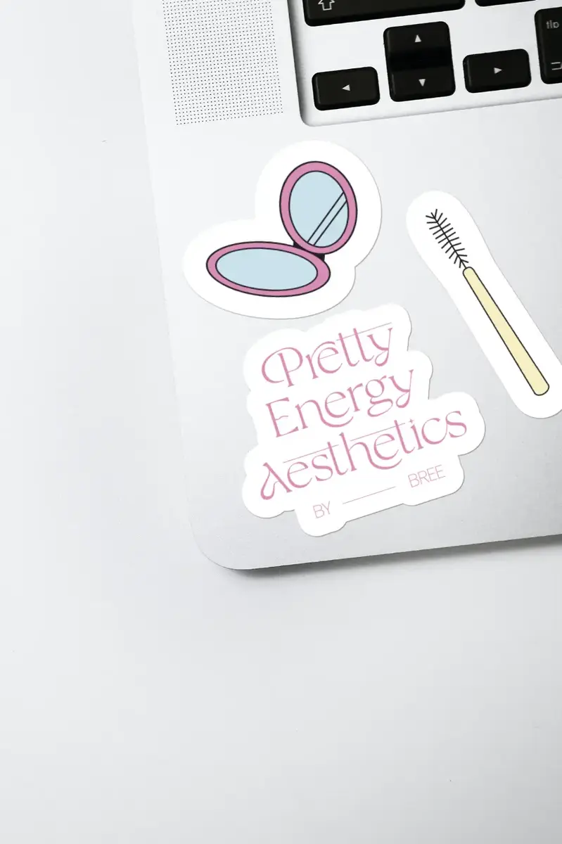 Pretty Energy Aesthetics stickers of a compact mirror and a mascara wand on a laptop
