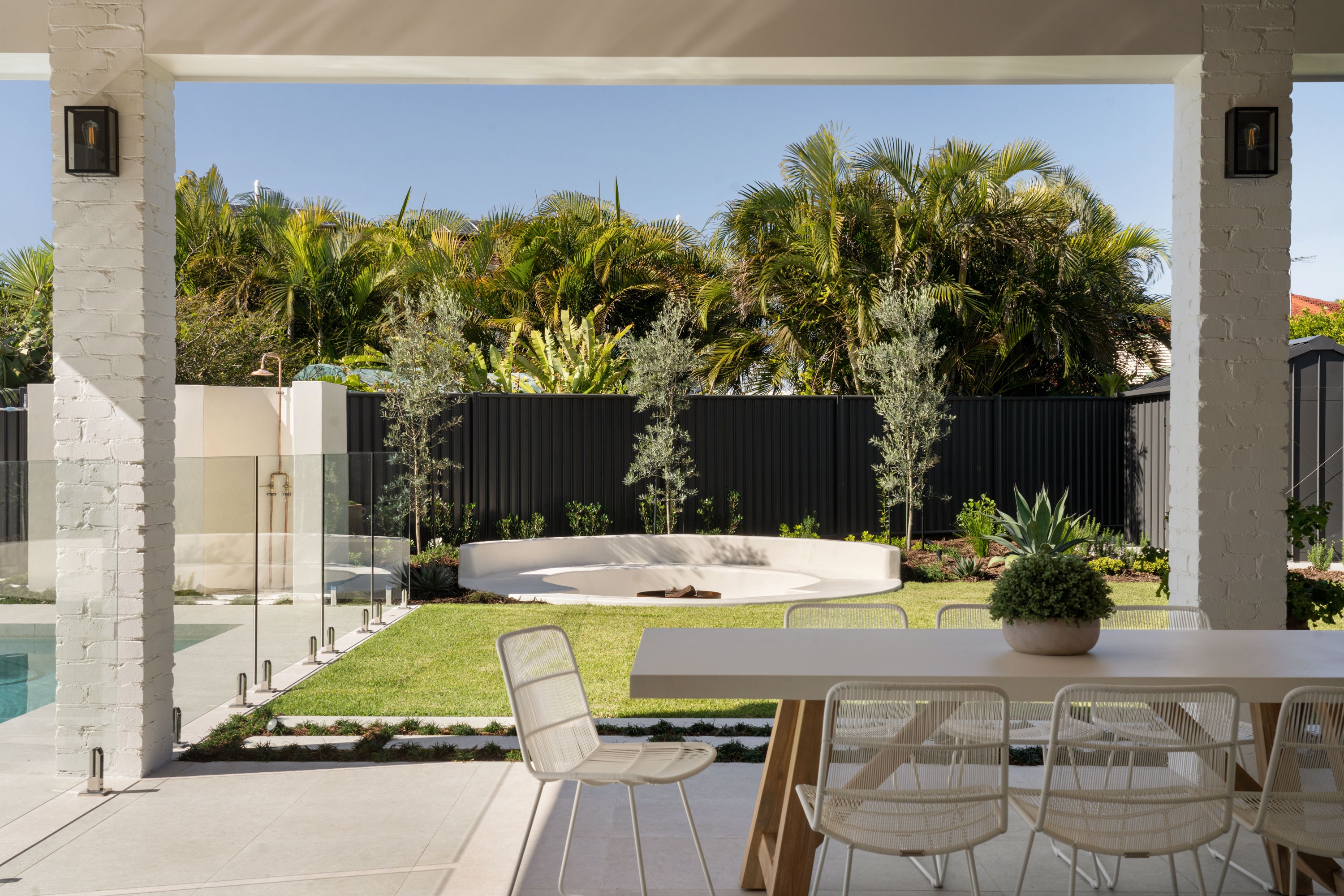 Resort style backyard with fire pit and modern rear facade