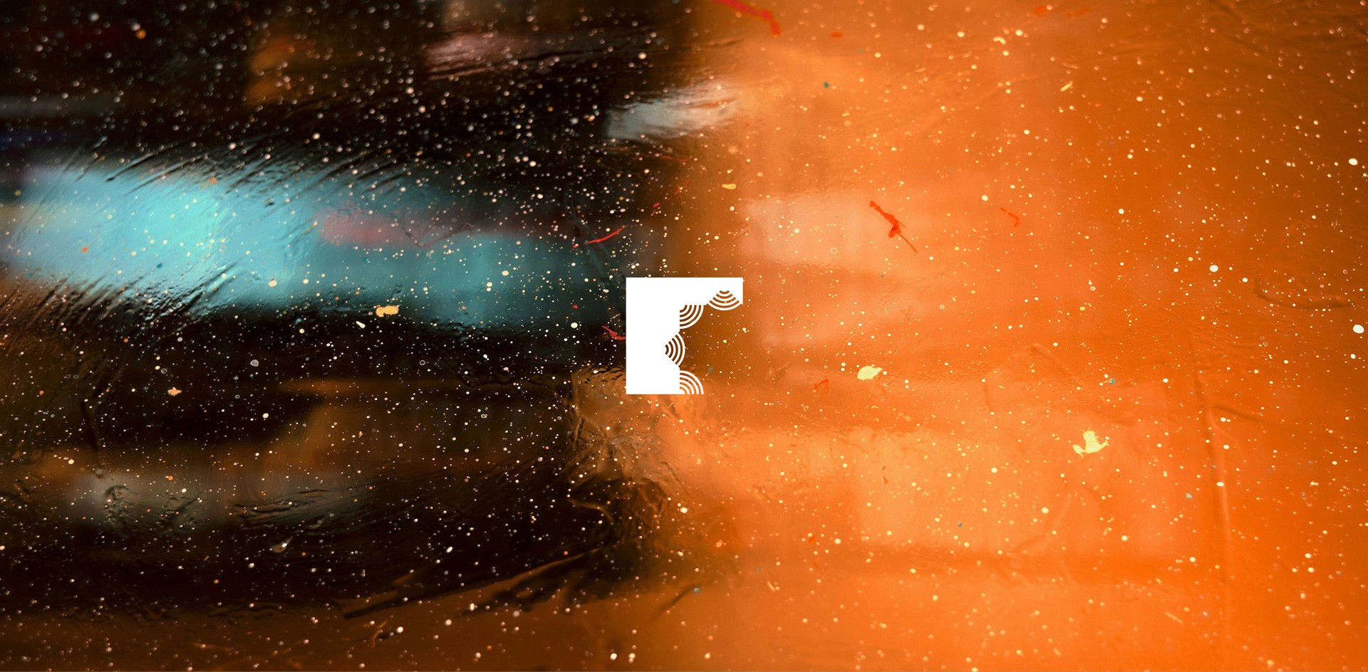 A dynamic blend of blue and orange abstract textures meet at a geometric, centered logo, creating a vibrant contrast with scattered light reflections.